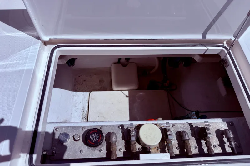 Slide: The Image of Open hatch of a 2004 Cabo 35 Flybridge boat, showing internal components and controls. - 57