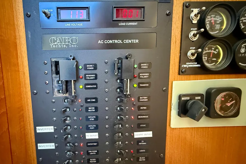 Slide: The Image of AC control panel of a 2004 Cabo 35 Flybridge yacht with gauges and switches. - 30
