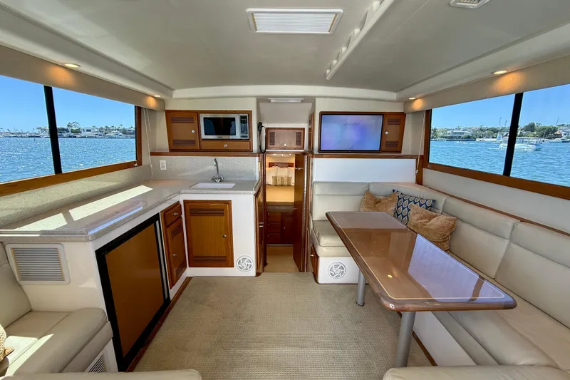 Slide: The Image of Interior of 2004 Cabo 35 Flybridge yacht with modern kitchen and seating area. - 19
