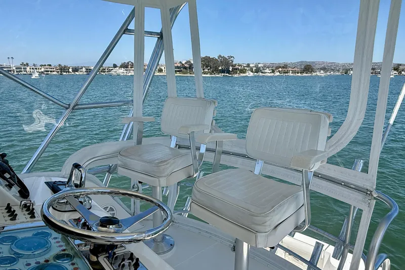 Slide: The Image of Flybridge of 2004 Cabo 35, featuring helm chairs and ocean view. - 41