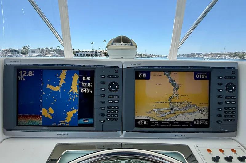 Slide: The Image of Garmin GPS displays on 2004 Cabo 35 Flybridge boat, showing navigation and depth information. - 39