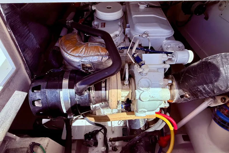 Slide: The Image of Engine compartment of a 2004 Cabo 35 Flybridge boat, showcasing mechanical components. - 60