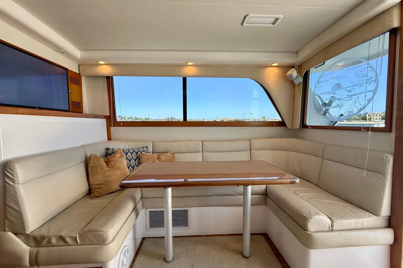 Slide: The Image of Luxurious interior of 2004 Cabo 35 Flybridge yacht with plush seating and elegant table. - 24