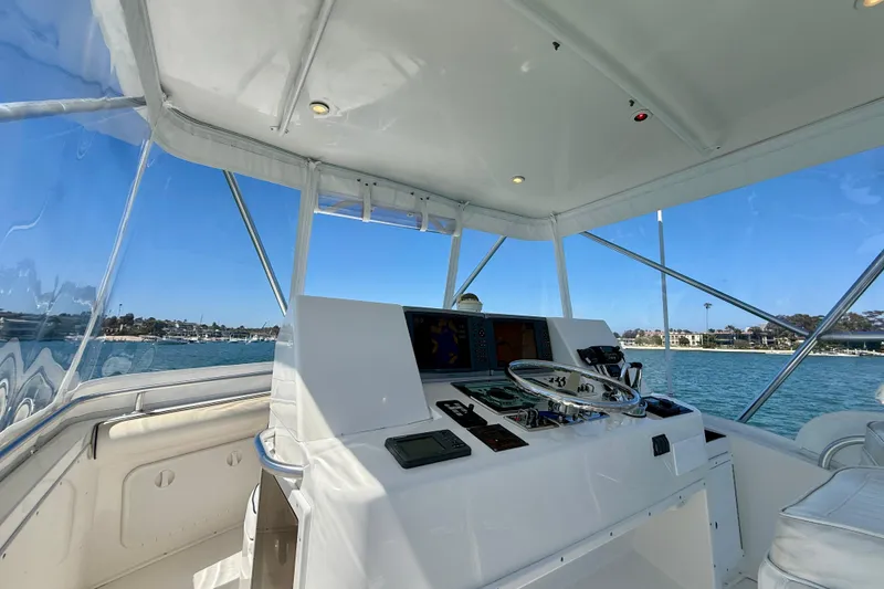 Slide: The Image of Helm of 2004 Cabo 35 Flybridge yacht with ocean view and navigation equipment. - 47