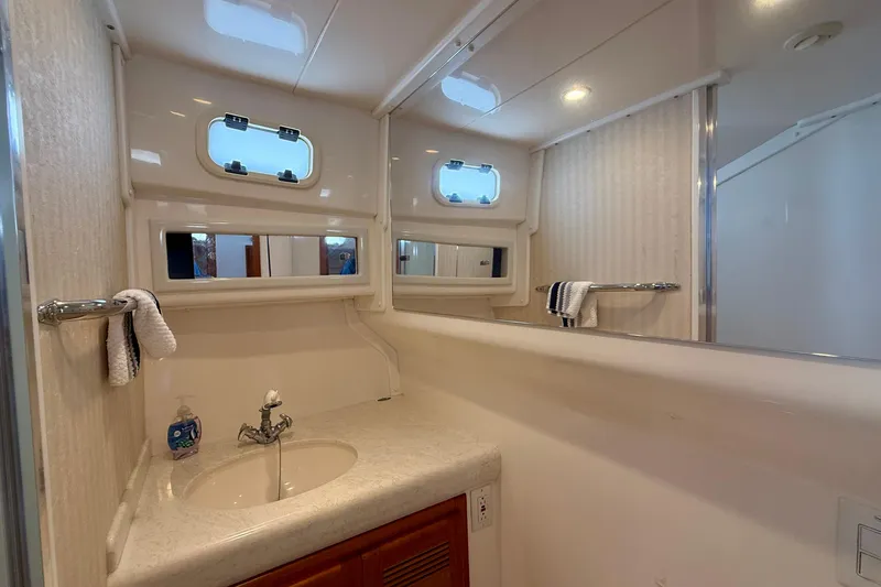 Slide: The Image of Bathroom interior of 2004 Cabo 35 Flybridge yacht with sink and mirror. - 18