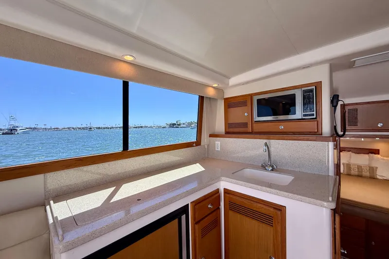 Slide: The Image of Luxurious 2004 Cabo 35 Flybridge yacht interior with kitchenette and ocean view. - 20