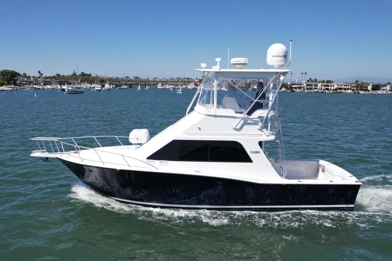 Slide: The Image of 2004 Cabo 35 Flybridge yacht cruising on a sunny day in a marina. - 9