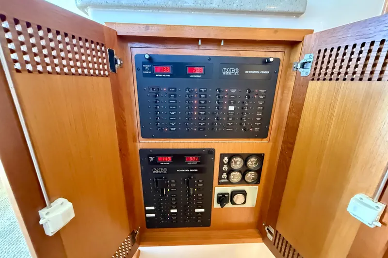 Slide: The Image of Electrical control panel inside a 2004 Cabo 35 Flybridge yacht, featuring DC and AC systems. - 33