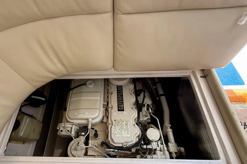Slide: The Image of Engine compartment of a 2004 Cabo 35 Flybridge boat, featuring a Caterpillar engine. - 64