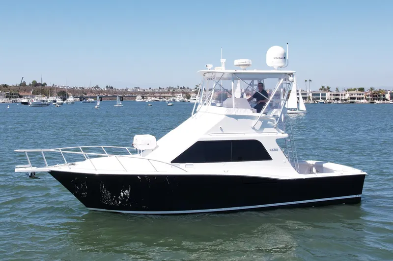 Slide: The Image of 2004 Cabo 35 Flybridge boat cruising on a sunny day in a marina. - 1
