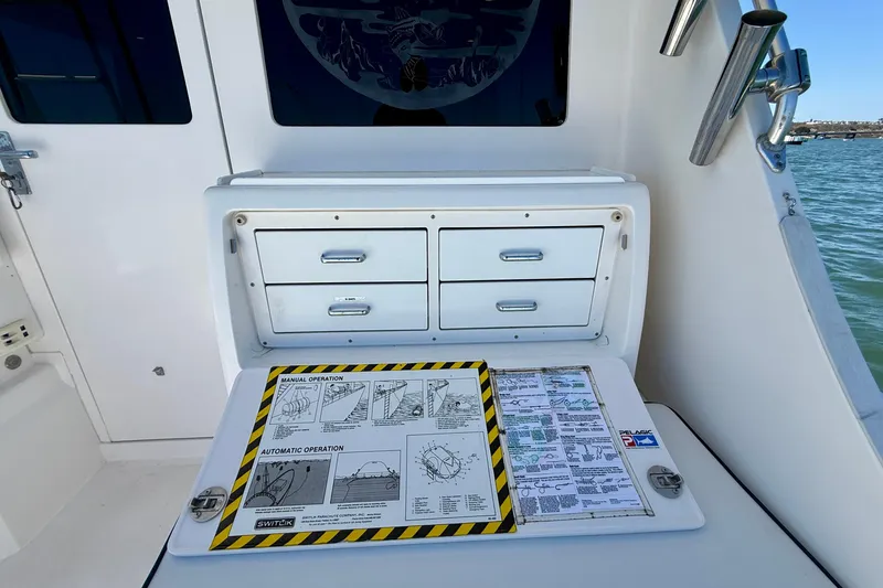 Slide: The Image of Control panel and storage on a 2004 Cabo 35 Flybridge boat. - 50