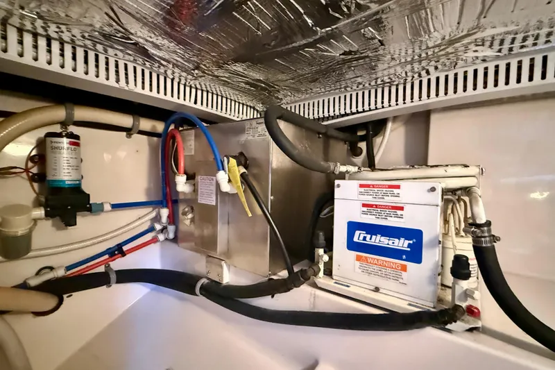 Slide: The Image of Engine room of a 2004 Cabo 35 Flybridge with Cruisair system and plumbing components. - 70