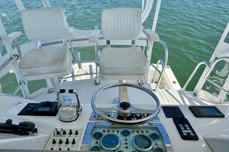 Slide: The Image of Helm of 2004 Cabo 35 Flybridge with dual seats and navigational controls. - 43