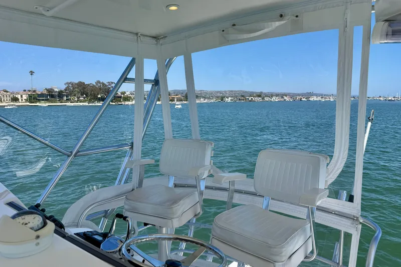 Slide: The Image of Flybridge view from 2004 Cabo 35, overlooking serene waters and coastal scenery. - 46