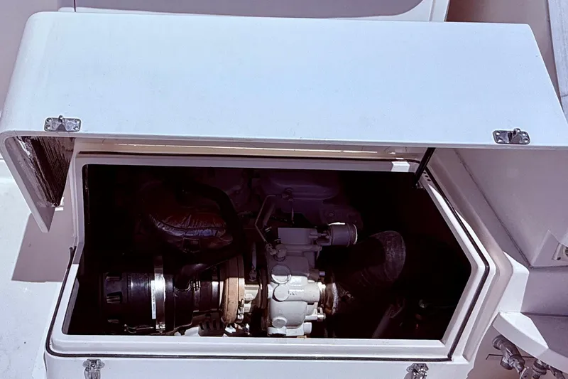 Slide: The Image of Engine compartment of a 2004 Cabo 35 Flybridge boat with open hatch. - 59