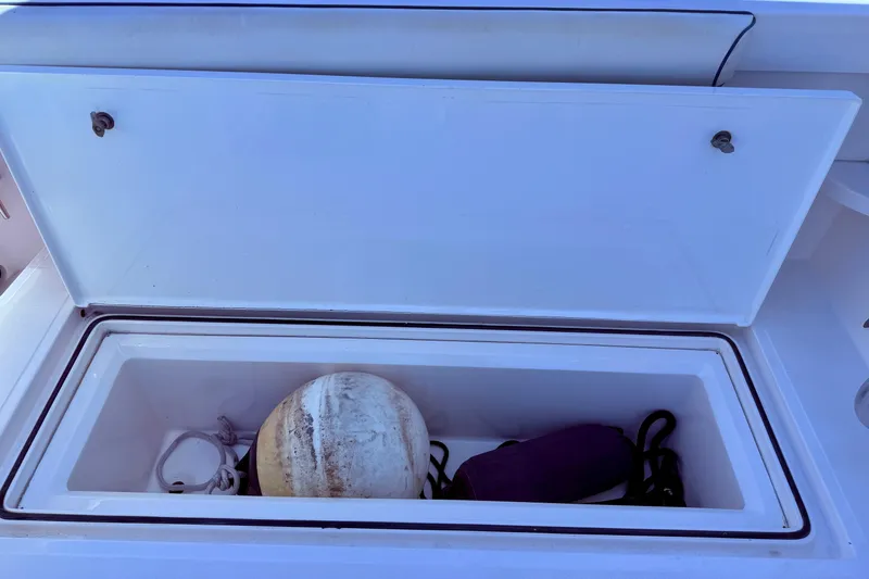 Slide: The Image of Open storage compartment on 2004 Cabo 35 Flybridge boat with marine equipment. - 58