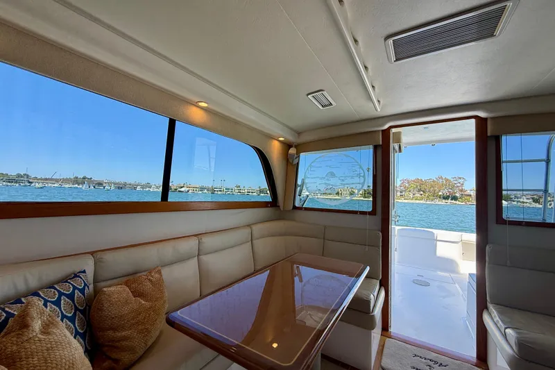 Slide: The Image of Interior of 2004 Cabo 35 Flybridge yacht with waterfront view through large windows. - 27