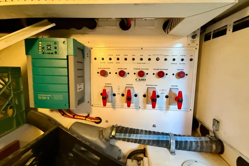 Slide: The Image of Electrical panel and charger in a 2004 Cabo 35 Flybridge boat engine room. - 72
