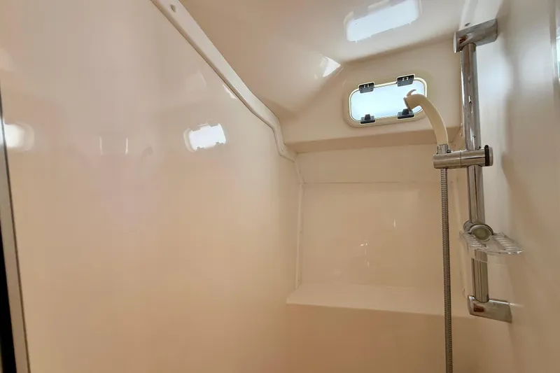 Slide: The Image of Interior shower of 2004 Cabo 35 Flybridge boat with window and showerhead. - 17