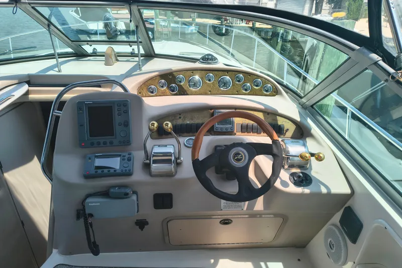 Slide: The Image of 2001 Sea Ray 340 Sundancer helm with steering wheel, gauges, and navigation equipment. - 8