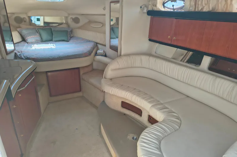 Slide: The Image of Interior of 2001 Sea Ray 340 Sundancer yacht with cozy seating and bed area. - 9