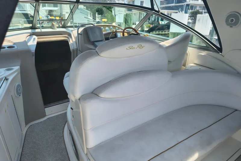 Slide: The Image of Interior of a 2001 Sea Ray 340 Sundancer boat with white seating and helm. - 6