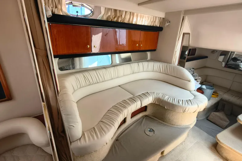 Slide: The Image of Luxurious interior of 2001 Sea Ray 340 Sundancer yacht with plush seating and wooden cabinets. - 11