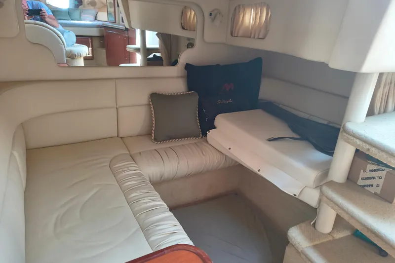 Slide: The Image of Interior of 2001 Sea Ray 340 Sundancer yacht with beige seating and cushions. - 13