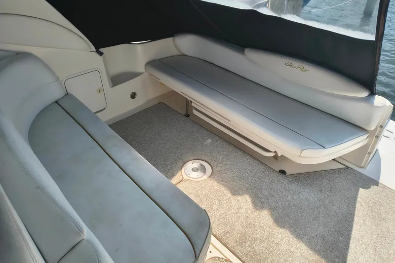 Slide: The Image of Interior seating of 2001 Sea Ray 340 Sundancer boat, featuring cushioned benches and carpeted flooring. - 5