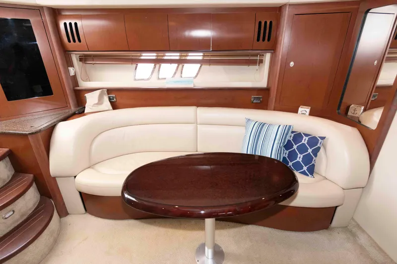 Slide: The Image of Luxurious interior of 2007 Sea Ray 44 Sundancer with elegant seating and wooden table. - 14