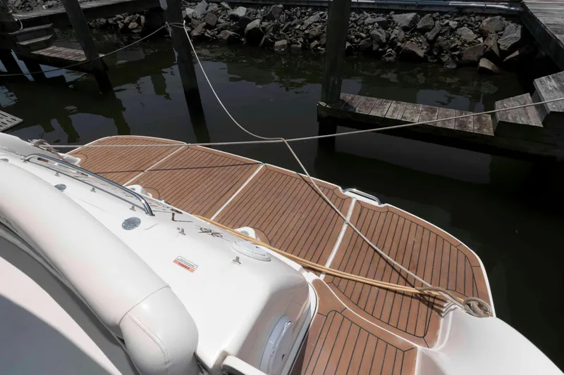 Slide: The Image of 2007 Sea Ray 44 Sundancer boat docked with wooden deck and mooring lines. - 4