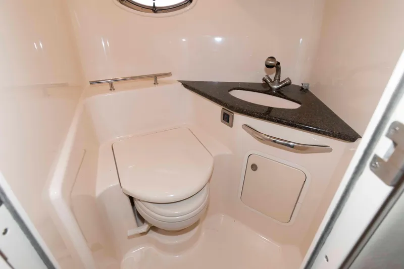 Slide: The Image of 2007 Sea Ray 44 Sundancer yacht bathroom with compact toilet and sleek sink design. - 21