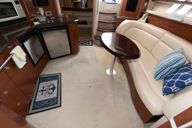 Slide: The Image of Interior of 2007 Sea Ray 44 Sundancer yacht with kitchenette and seating area. - 16