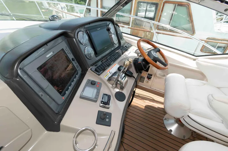 Slide: The Image of 2007 Sea Ray 44 Sundancer helm with modern controls and luxurious seating. - 8
