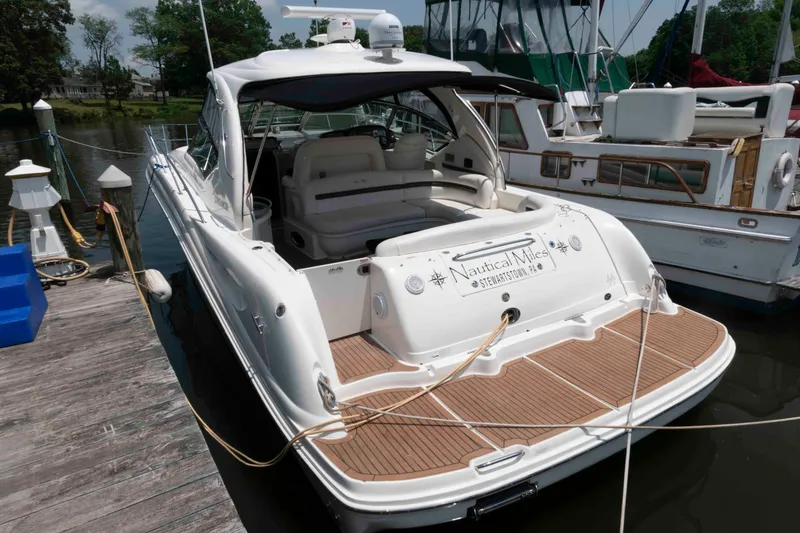 Slide: The Image of 2007 Sea Ray 44 Sundancer yacht docked, featuring spacious deck and sleek design. - 3