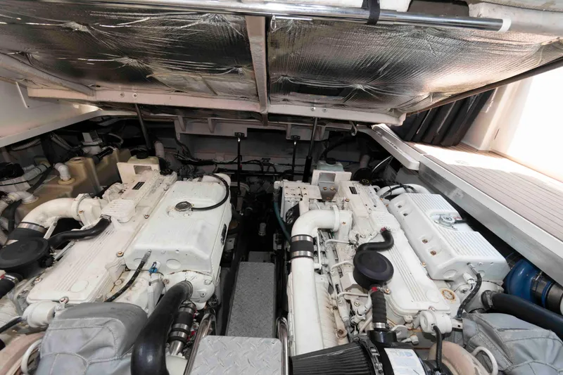 Slide: The Image of Engine room of 2007 Sea Ray 44 Sundancer yacht, showcasing dual engines and mechanical components. - 22