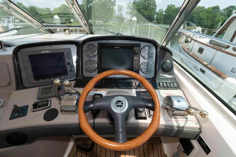 Slide: The Image of Helm of 2007 Sea Ray 44 Sundancer with wooden steering wheel and navigation controls. - 9