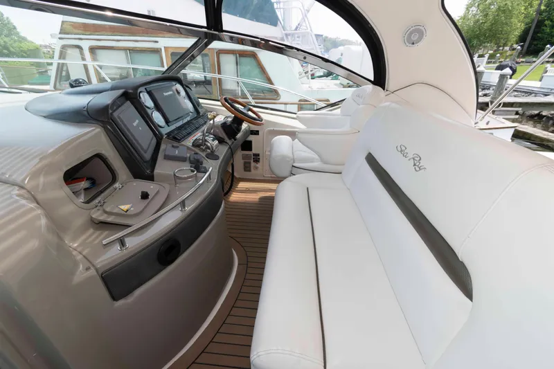 Slide: The Image of 2007 Sea Ray 44 Sundancer cockpit with white seating and modern control panel. - 7