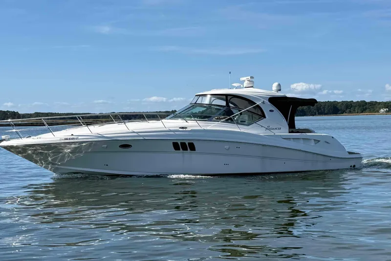 Slide: The Image of 2007 Sea Ray 44 Sundancer cruising on calm waters under a clear blue sky. - 1