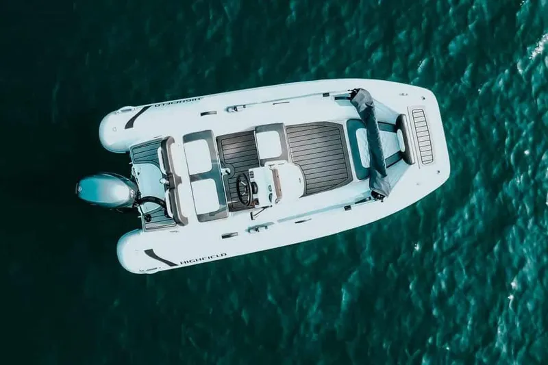 Slide: The Image of Manufacturer Provided Image: Aerial view of 2025 Highfield Sport 360 boat on turquoise water. - 7