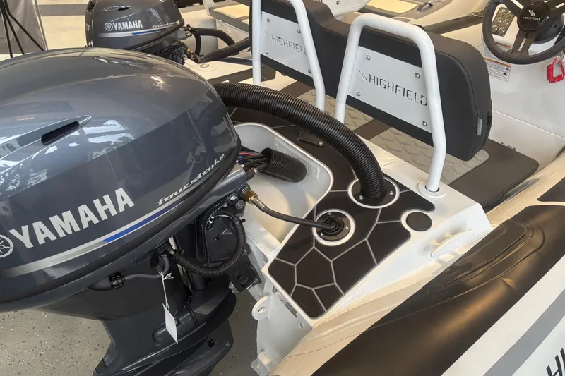 Slide: The Image of 2026 Highfield Sport 360 boat with Yamaha four-stroke engine, showcasing seating and controls. - 3