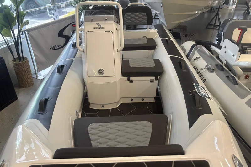 Slide: The Image of 2026 Highfield Sport 360 inflatable boat with sleek seating and modern design in showroom. - 4