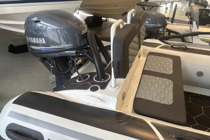 Slide: The Image of 2026 Highfield Sport 360 boat with Yamaha 40HP four-stroke engine, featuring cushioned seating. - 2