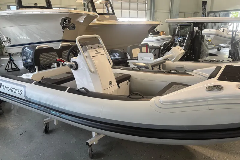 The Image of 2026 Highfield Sport 360 boat in showroom, featuring sleek design and modern controls. - 0