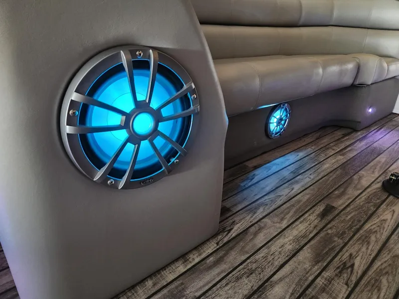 Slide: The Image of Illuminated speakers on a boat with wooden flooring and cushioned seating. - 8