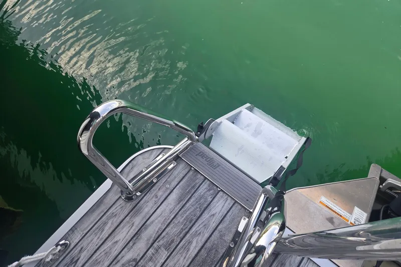 Slide: The Image of 2019 Veranda VTX 25RC boat ladder and deck over green water. - 15