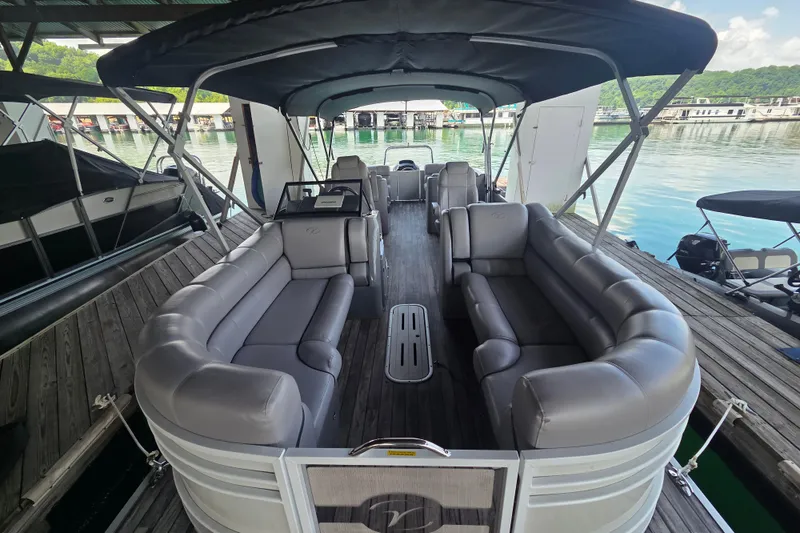 Slide: The Image of 2019 Veranda VTX 25RC pontoon boat with spacious seating, docked on calm water. - 13