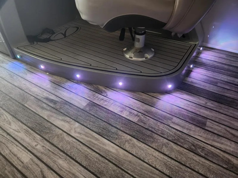 Slide: The Image of Illuminated boat interior with wooden flooring and seating area. - 9