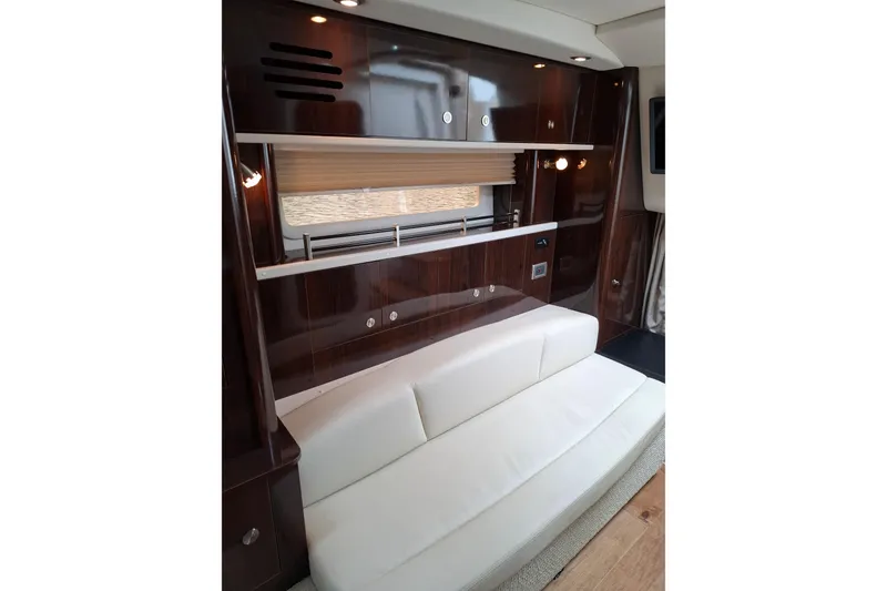 Slide: The Image of Interior of 2016 Sea Ray Sundancer 330 yacht with sleek wood cabinetry and white seating. - 18