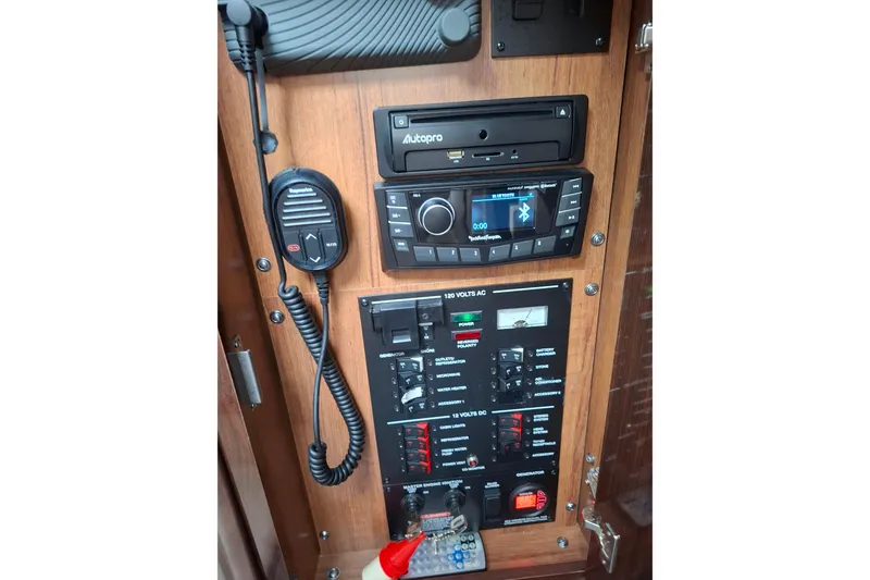 Slide: The Image of Control panel of a 2016 Sea Ray Sundancer 330 boat with radio and communication equipment. - 22